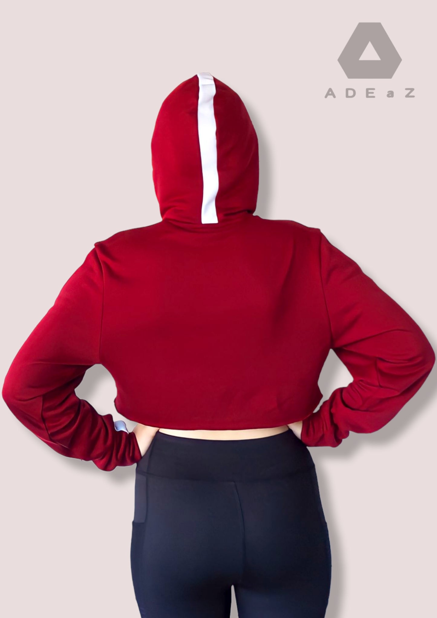 Red long-sleeve hot crop top with a hoodie, showcasing a form-fitting design and trendy style.
